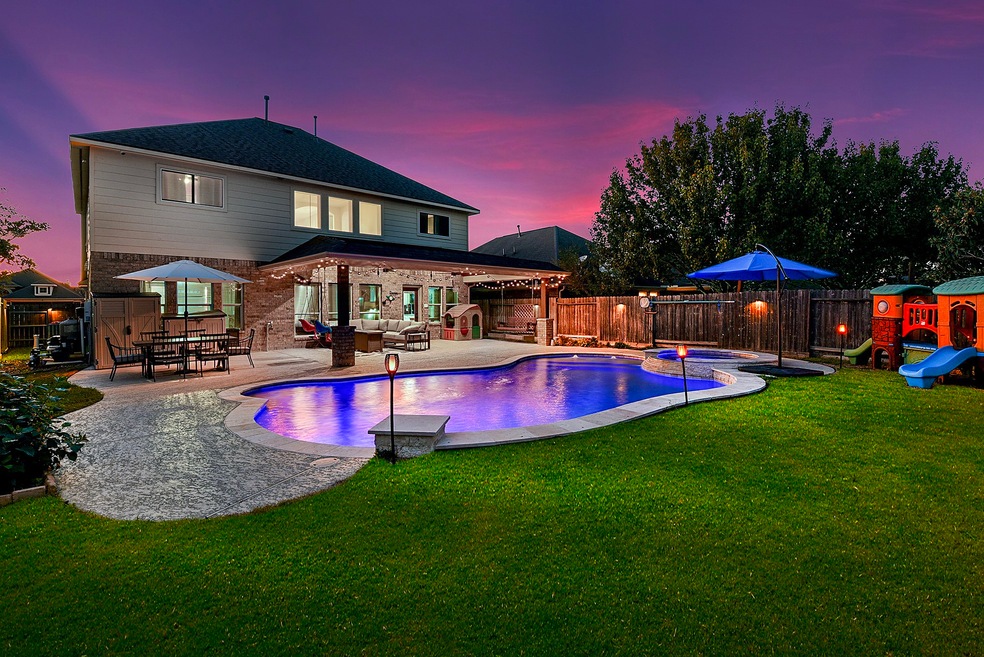 Welcome home. Come outside and relax in your heated spa and pool or enjoy the large custom extended patio!