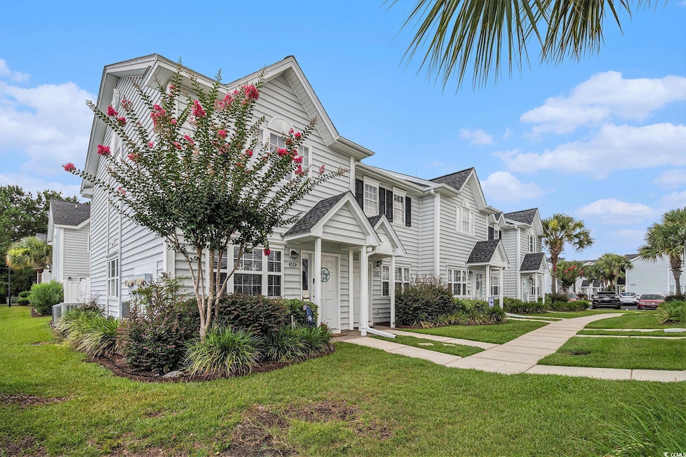 View of property with a front yard