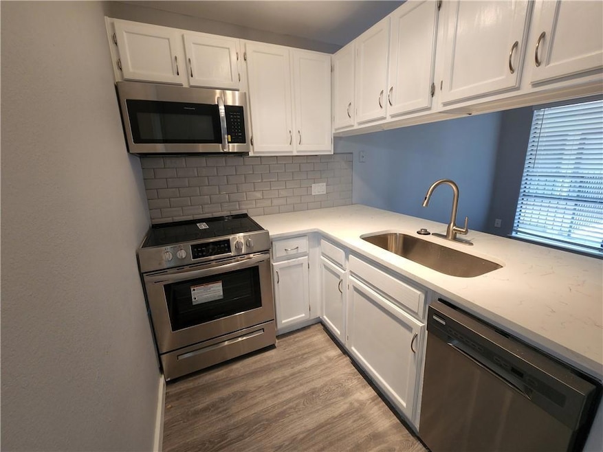 Kitchen featuring appliances with stainless steel