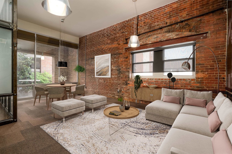 Living room featuring brick wall, a wealth of natu