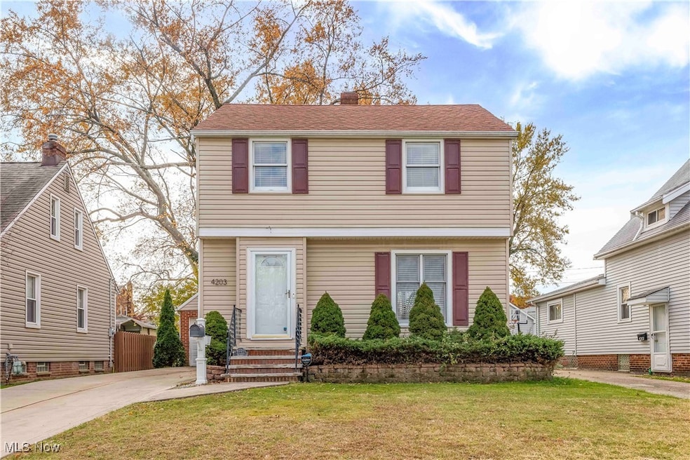 Colonial house featuring a chimney, a front lawn, and entry steps
