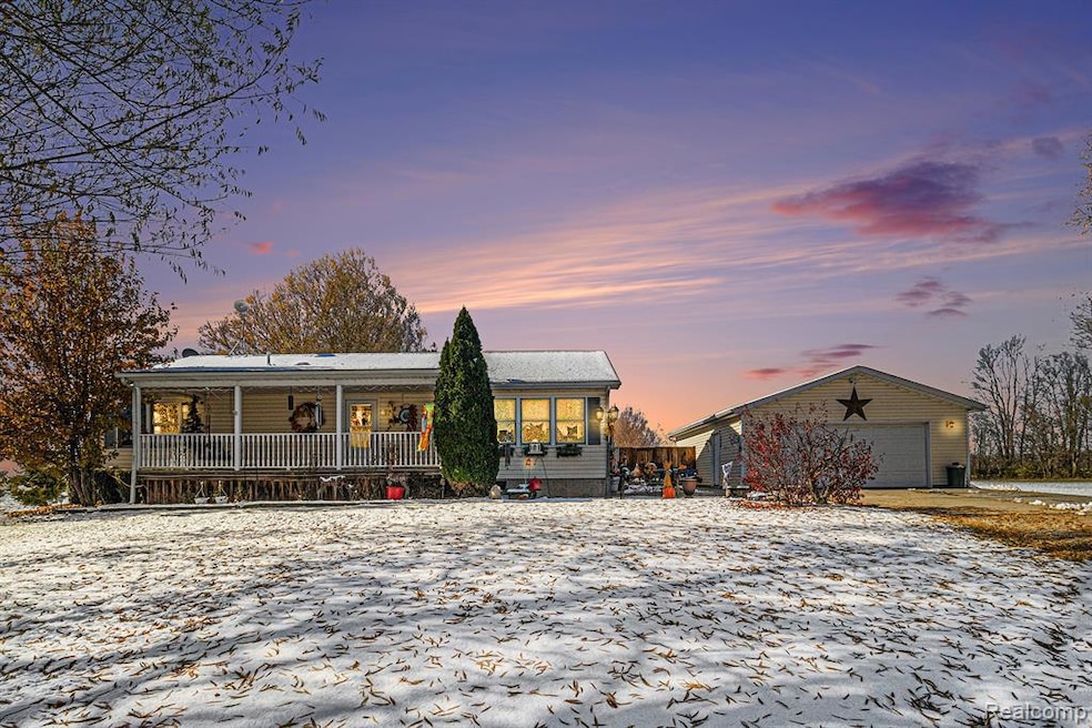 Ranch-style house with an outdoor structure and a porch