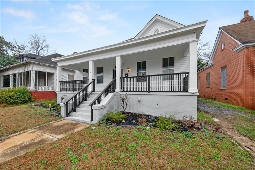 Neoclassical home featuring a porch and a front la