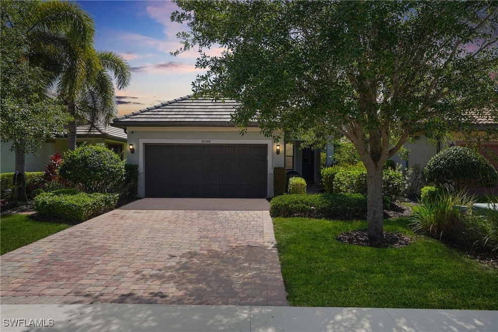 View of front of house with decorative driveway, a
