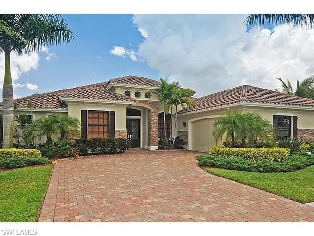 Custom stone accents & extra wide paver driveway.