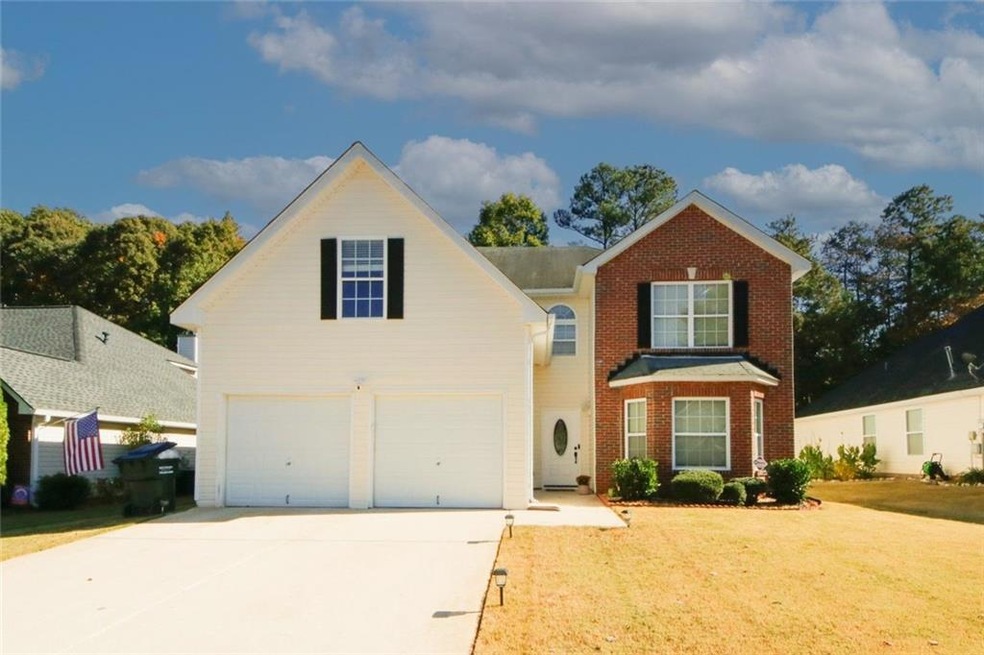 Front facade featuring a front lawn and a garage