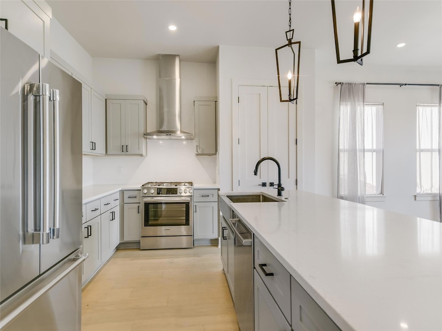 Kitchen with stainless steel appliances, wall chi