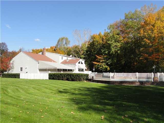 Exterior Back. Set in private wooded setting, Stat