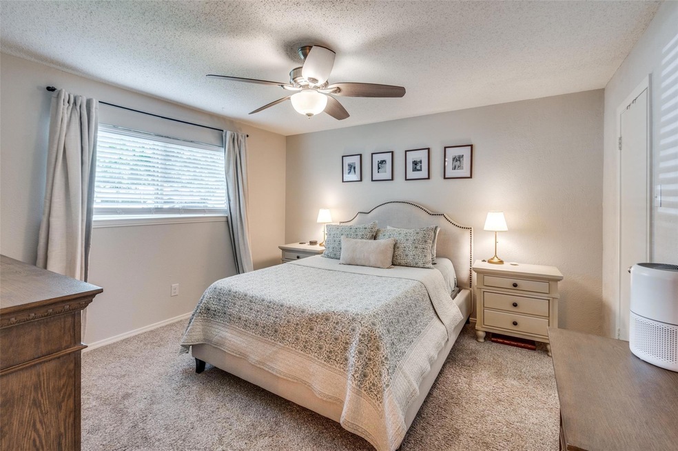 Carpeted bedroom featuring a textured ceiling and 