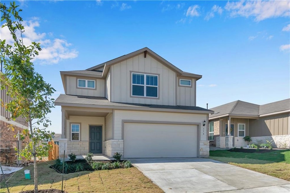 Craftsman house featuring stone siding, board and batten siding, a front lawn, and an attached garage