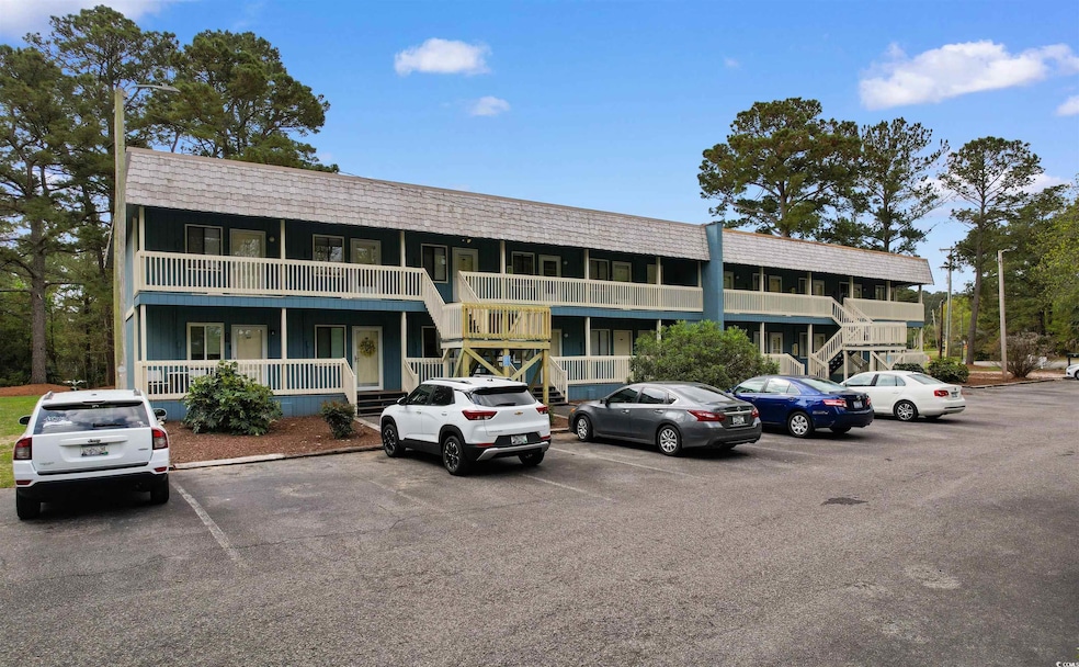 View of property with uncovered parking