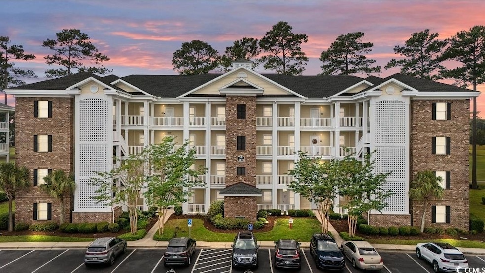 View of building exterior featuring uncovered parking