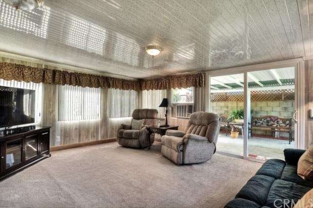 The family room is just off the kitchen and it is a wonderful feature of the home. With windows surrounding the room, the natural light, lights up the room and give an open feel of the room. The sliding door leads you out to the large yard. 