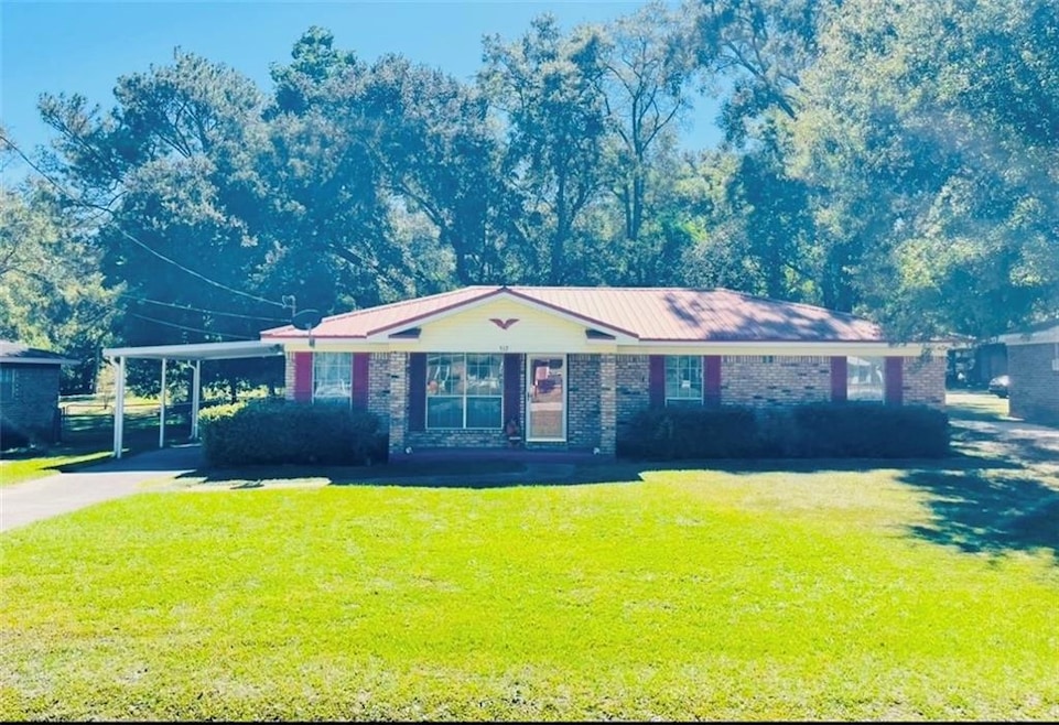 Ranch-style house with a front lawn and a carport