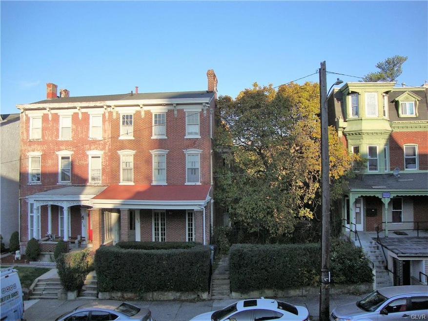 Double lot includes unit with red porch roof and l