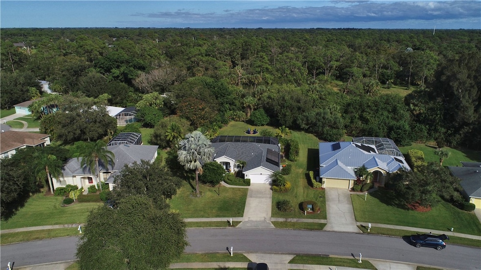 Aerial view of property's location with nearby suburban area and a forest
