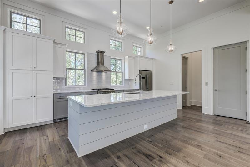 Oversized kitchen islands separate the the space a