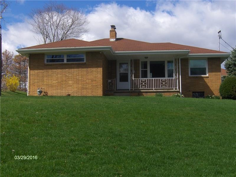 The house sits on a corner lot with fruit trees, b