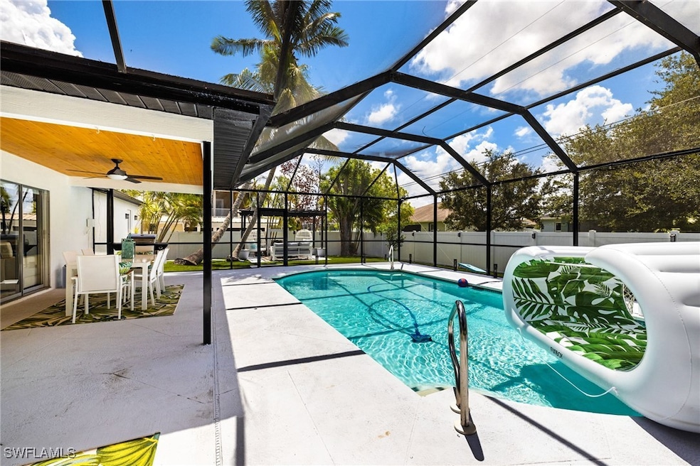 View of swimming pool with ceiling fan, a lanai, and a patio area