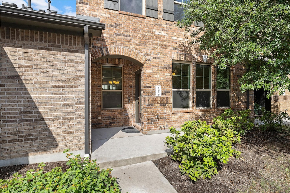 Doorway to property featuring brick siding