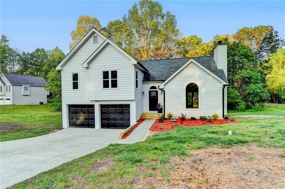 Tri-level home with an attached garage, a chimney,