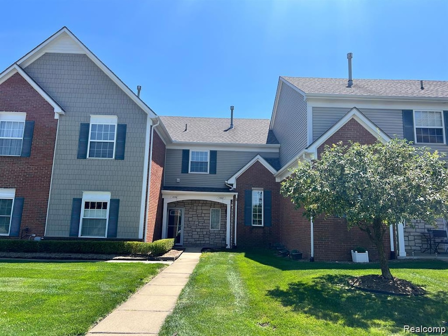 View of front of house featuring a front lawn and roof with shingles