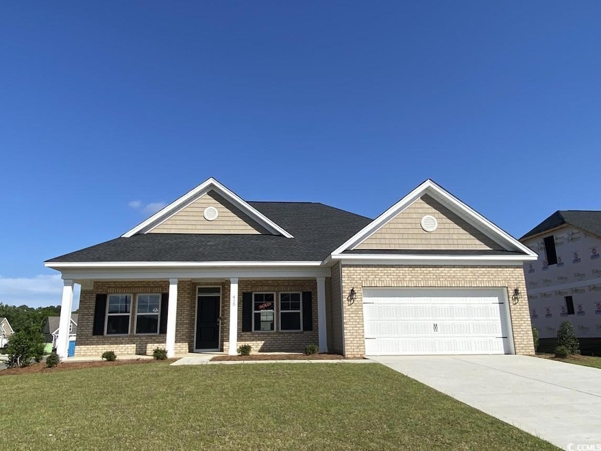 Craftsman inspired home featuring a garage, a porch, a front yard, brick siding, and driveway