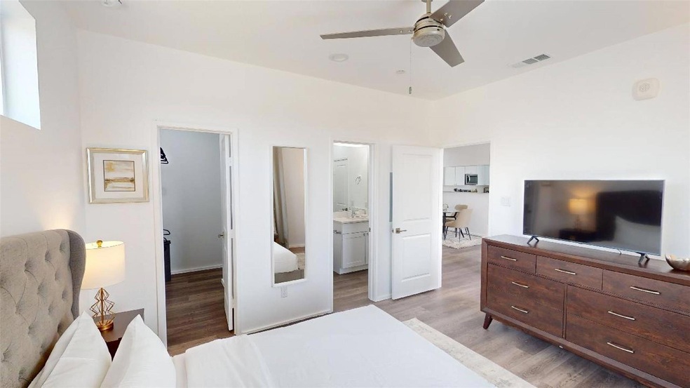 Bedroom with ceiling fan, connected bathroom, and 