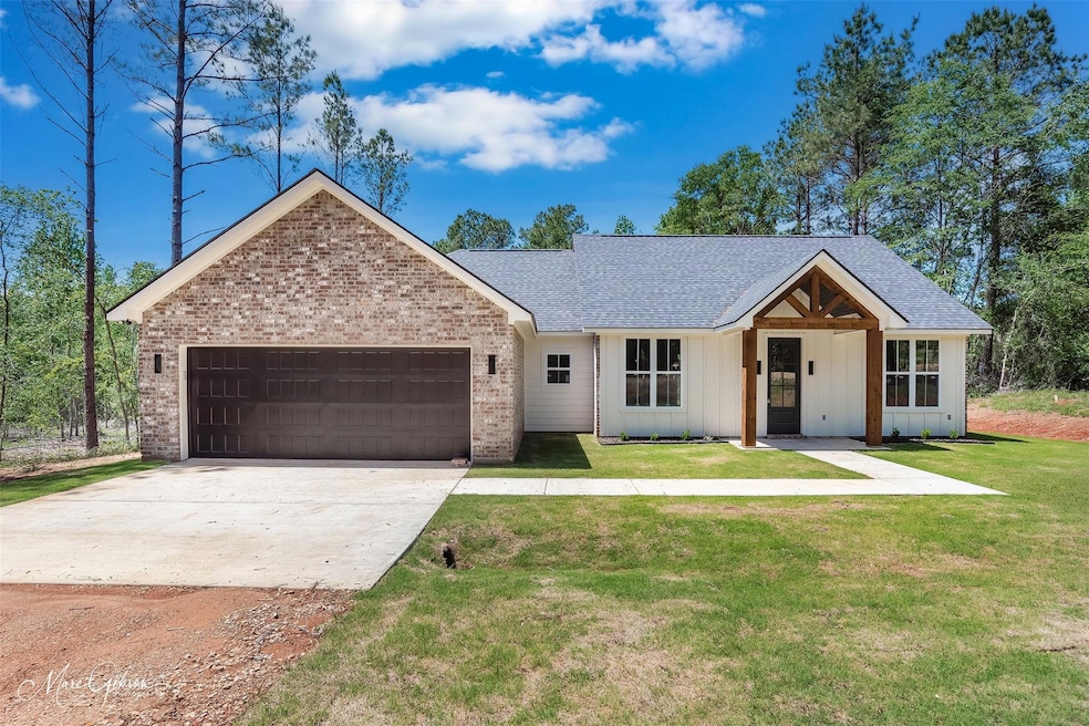 Ranch-style home with a garage, concrete driveway,