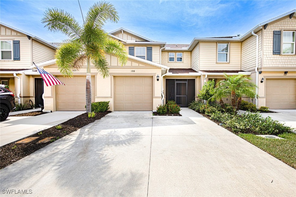 View of property featuring concrete driveway and a