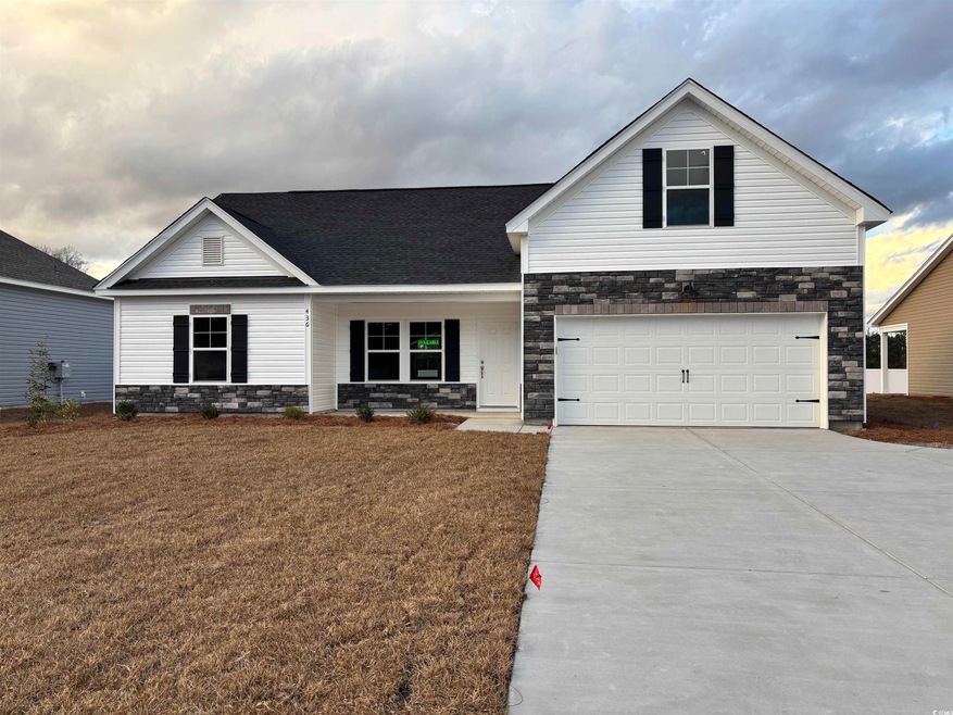 View of front of house with a garage and a front l