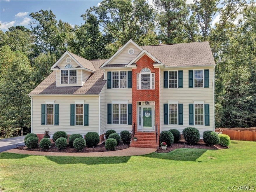 Wonderful setting with woods surrounding fenced ba