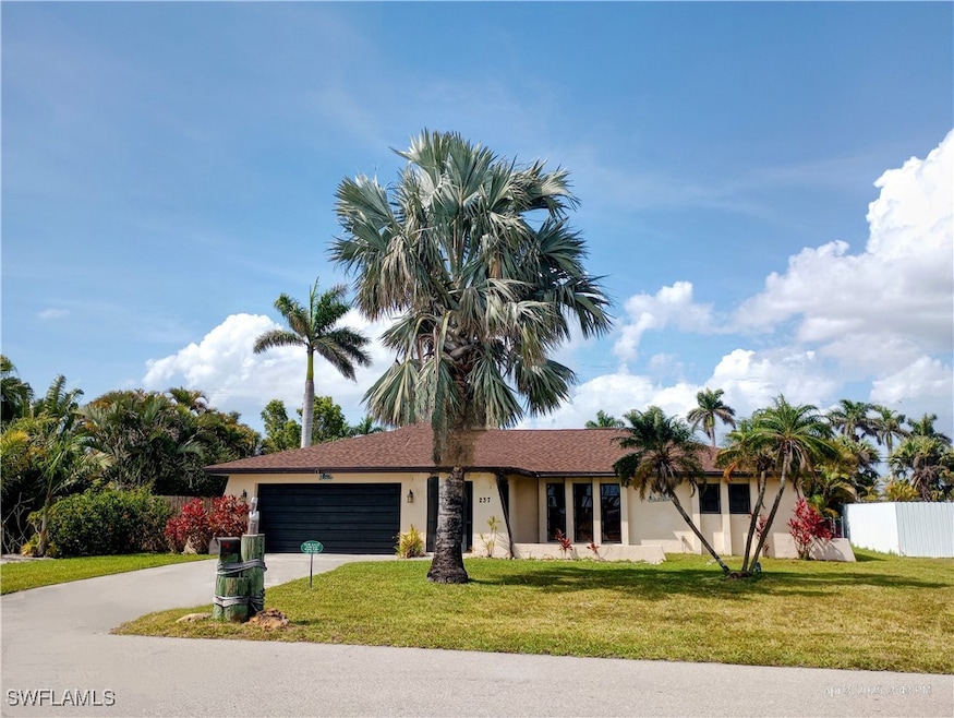 Ranch-style home featuring stucco siding, fence, d