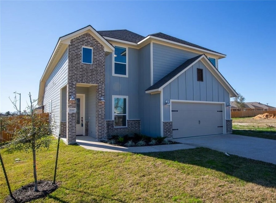 View of front of property with brick siding, an at
