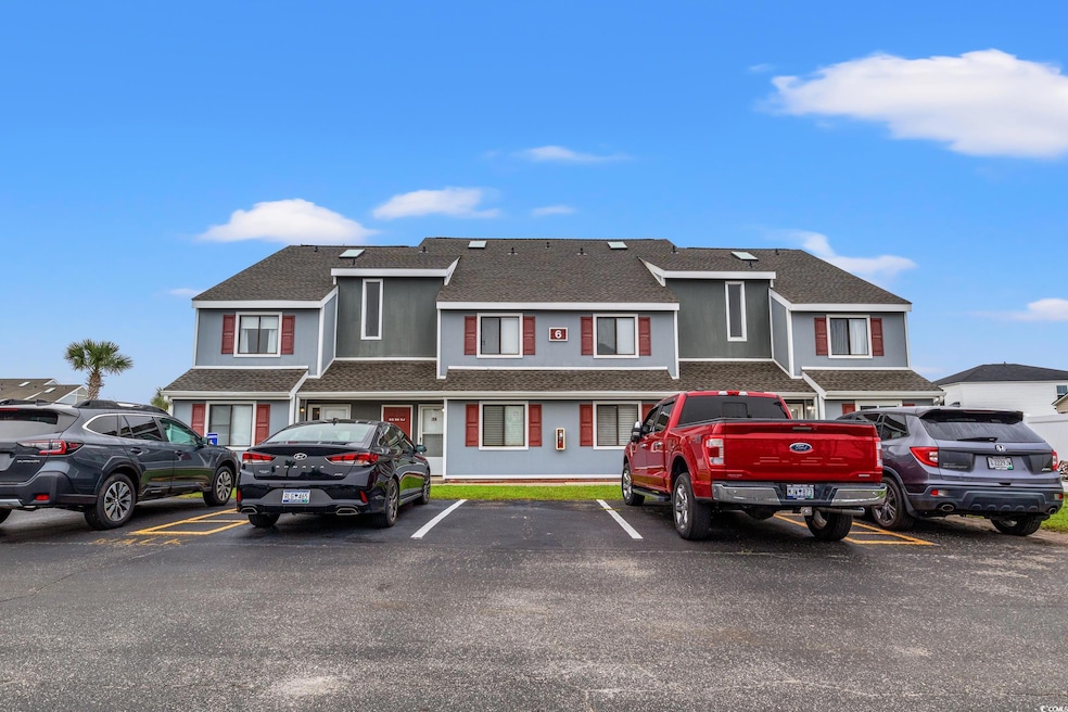 Multi unit property with roof with shingles, uncovered parking, and stucco siding