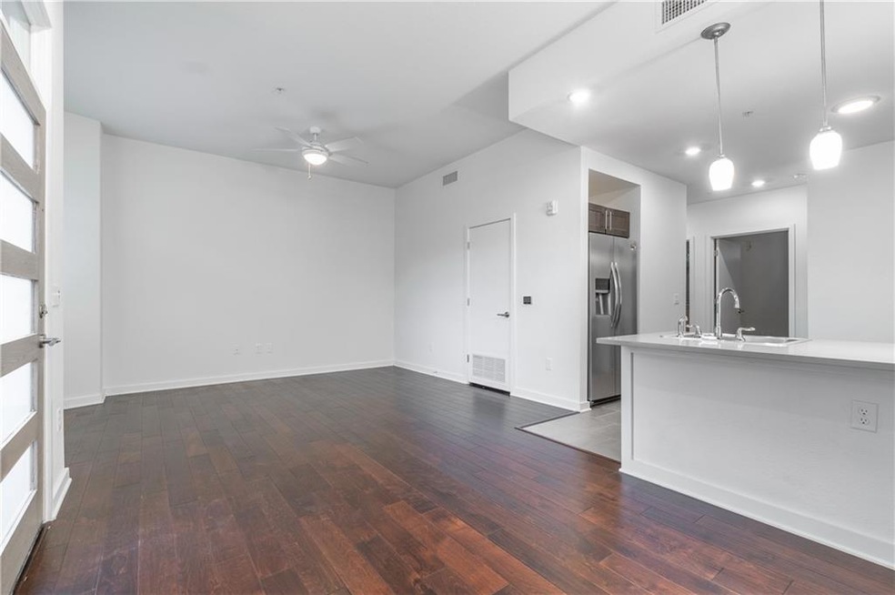 Unfurnished living room with a ceiling fan and da