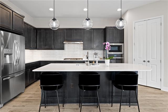 The kitchen shines with smooth quartz countertops,