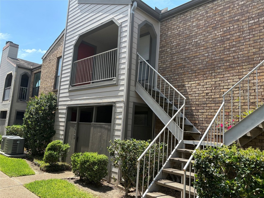 Second floor condo with a brick and siding exterio