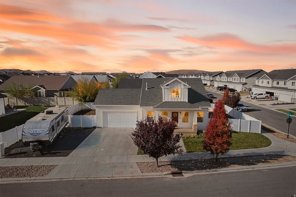 View of front of property featuring a porch, a residential view, driveway, and a garage