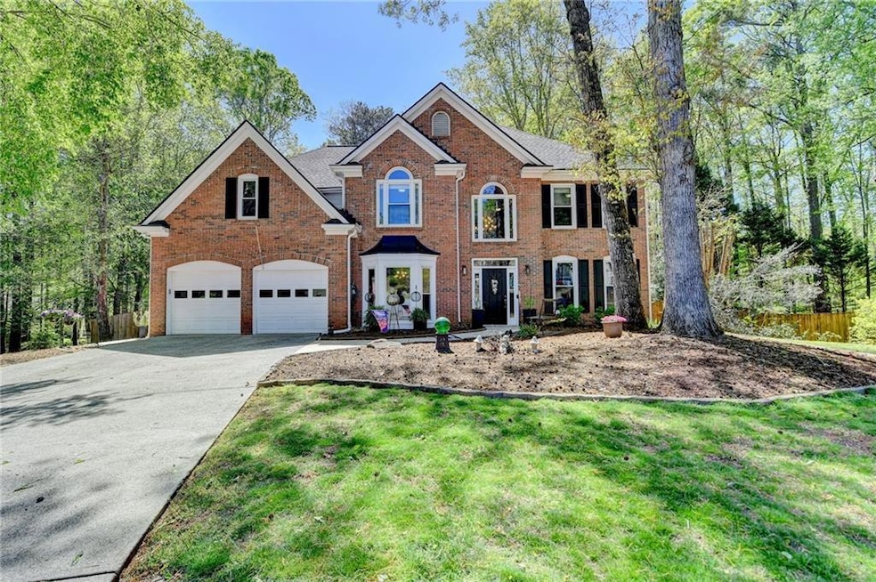 Colonial-style house featuring concrete driveway, 