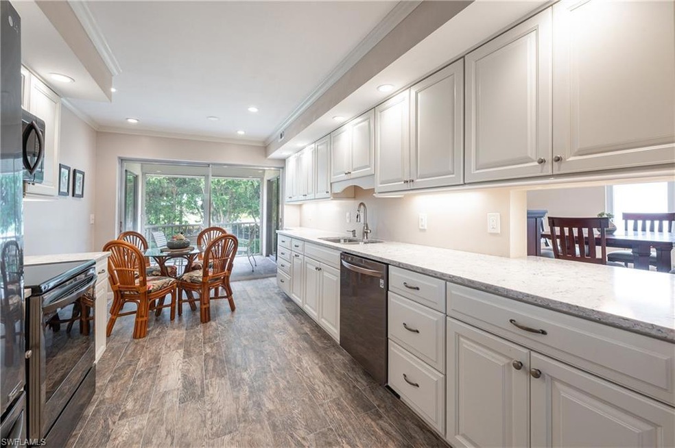 Kitchen with dishwasher, electric range oven, ornamental molding, dark wood-style floors, and white cabinetry