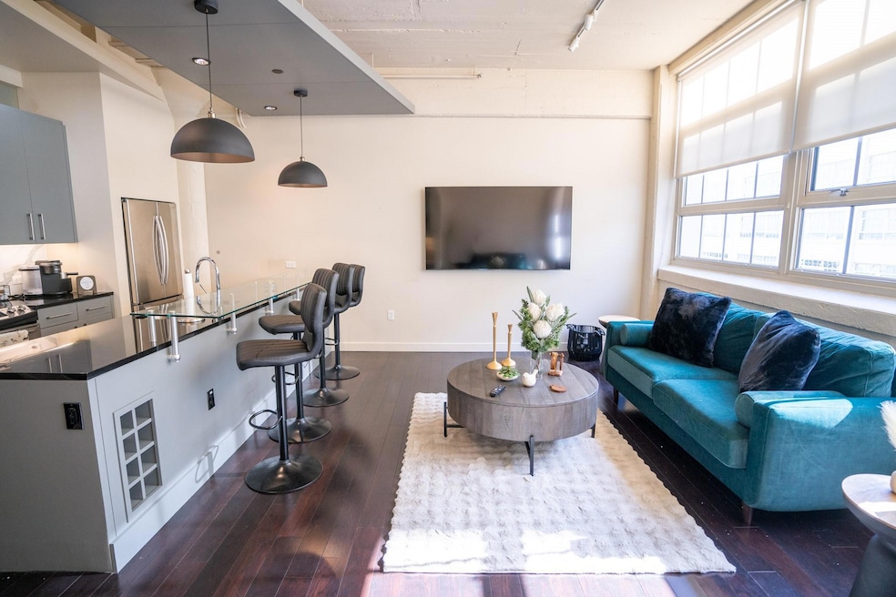 Living room featuring a towering ceiling, track li