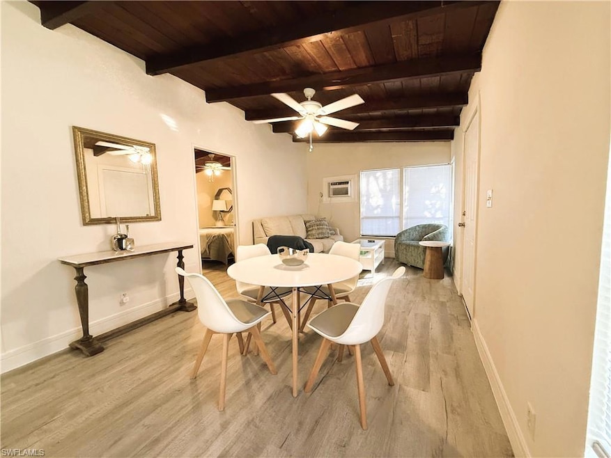 Dining space featuring beamed ceiling, ceiling fan