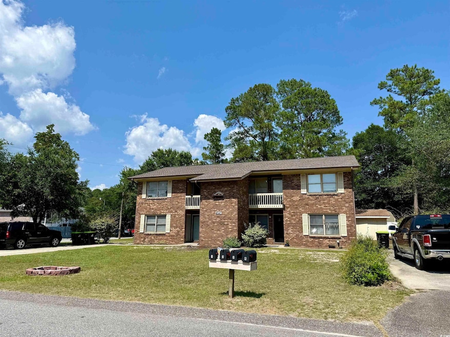 View of front of home with a front lawn and brick siding