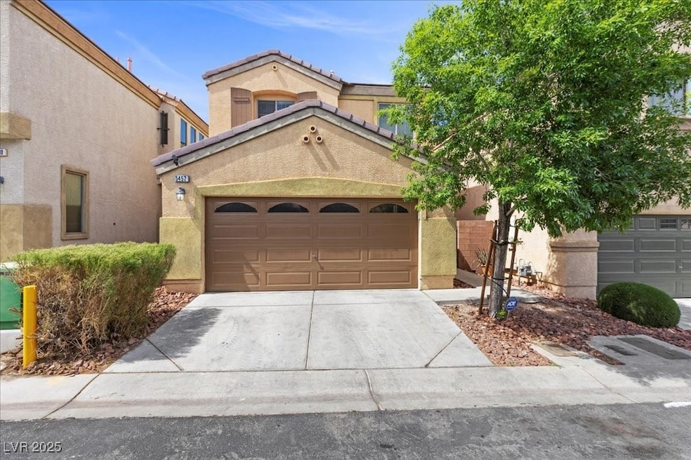 View of front of house with driveway, stucco sidin