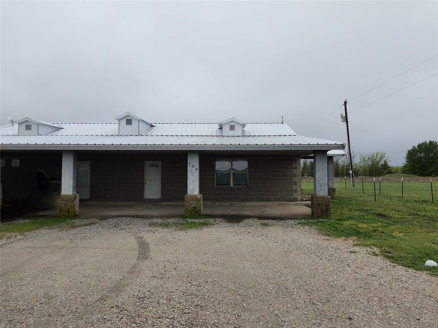 View of front of home featuring fence and metal roof