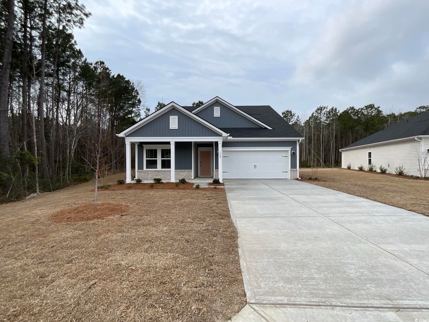 View of front of home featuring concrete driveway 