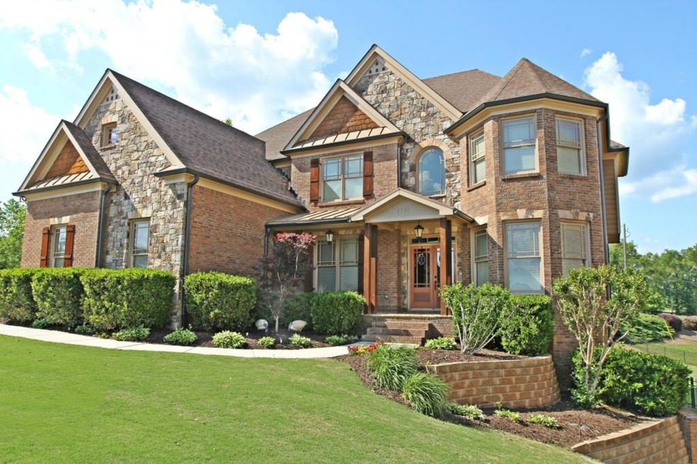 CRAFTSMAN'S STYLE THREE SIDED BRICK WITH STONE ACE