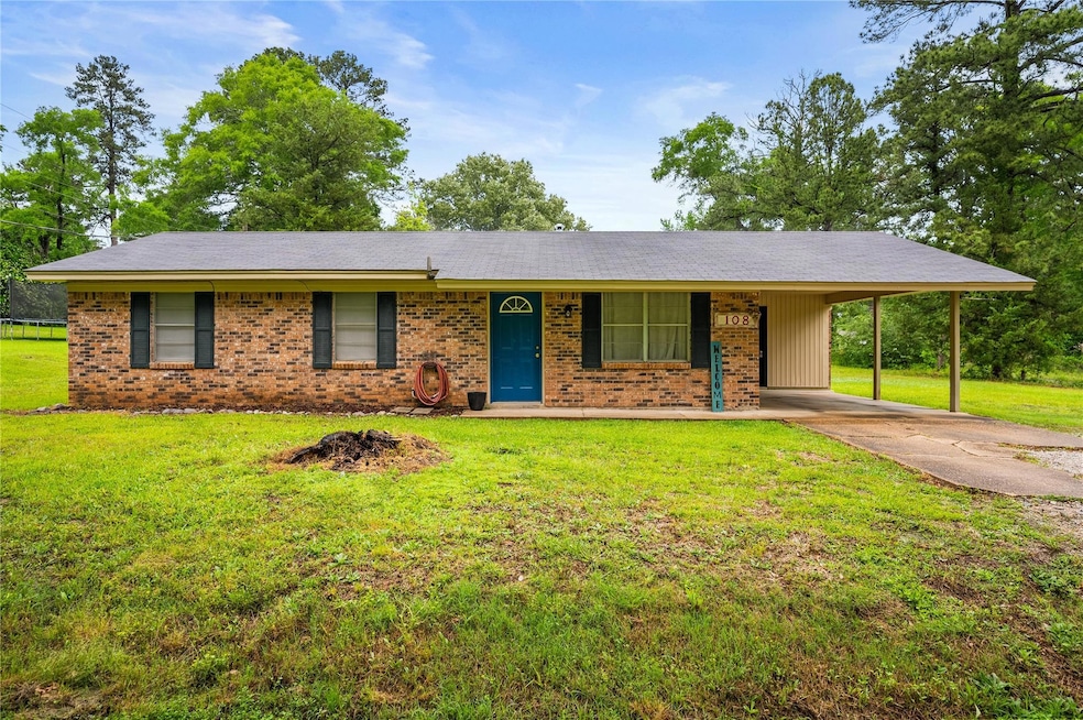 Ranch-style home featuring brick siding, a front l