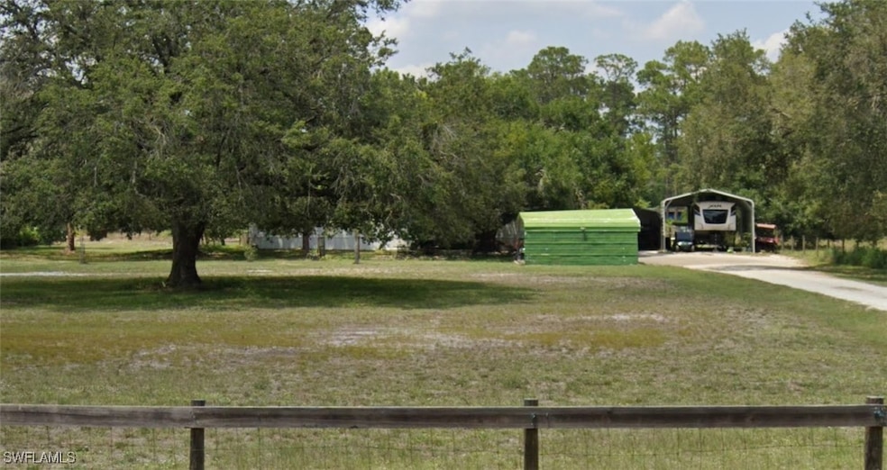 View of yard with a carport